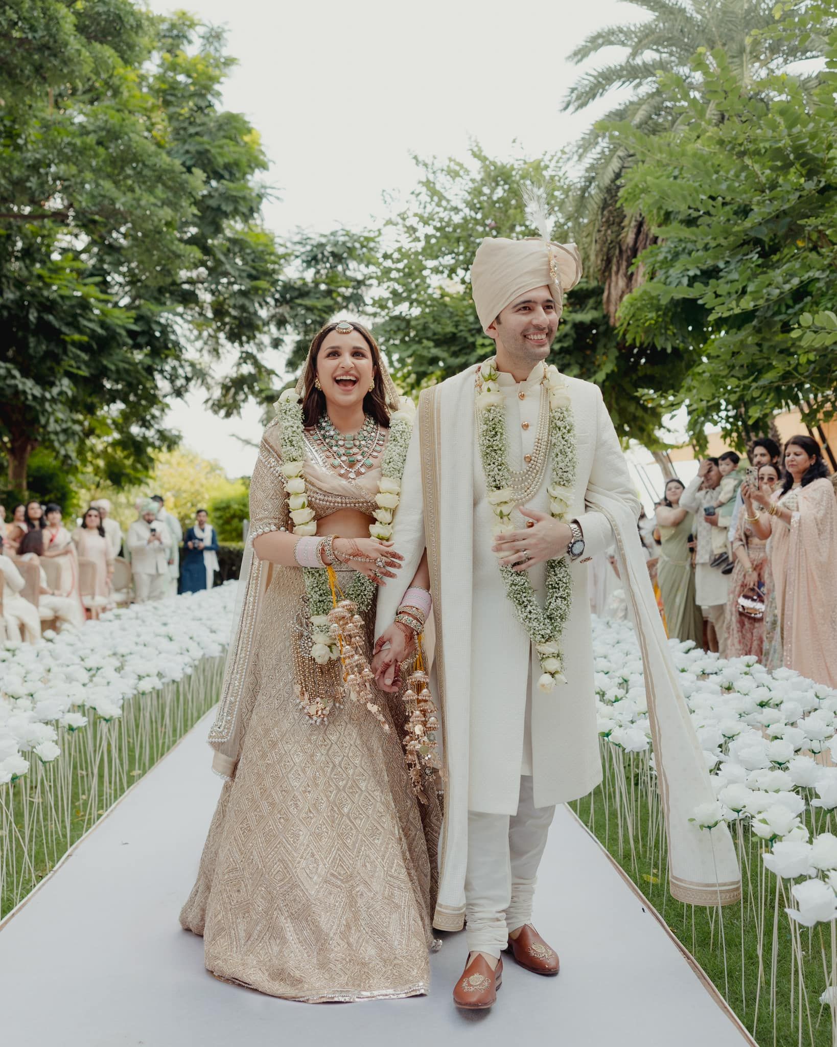 The pictures show the couple dressed for their day wedding in Udaipur — a blush lehenga for the bride and cream sherwani for the groom. 