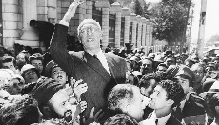 Prime Minister Mohammad Mossadegh rides on the shoulders of cheering crowds in Tehran's Majlis Square, outside the parliament building, after reiterating his oil nationalization views to his supporters on Sept. 27, 1951 || Photo: Collected