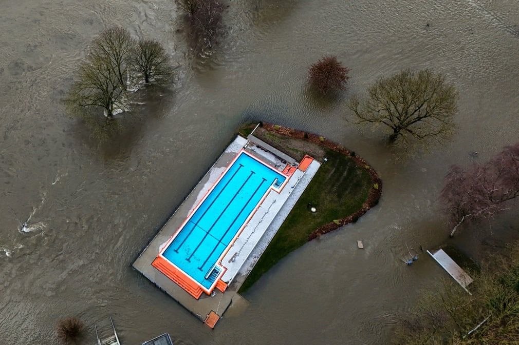 (Essen, Germany) A swimming pool surrounded by flood waters from the river Ruhr in Essen || Photograph: Ina Fassbender/AFP/Getty Images