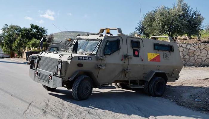 An Israeli military vehicle blocks a road during an Israeli raid || Photo: Reuters
