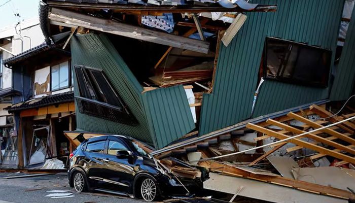 A damaged car stands near a collapsed house, following an earthquake, in Nanao, Ishikawa prefecture || Photo: Reuters