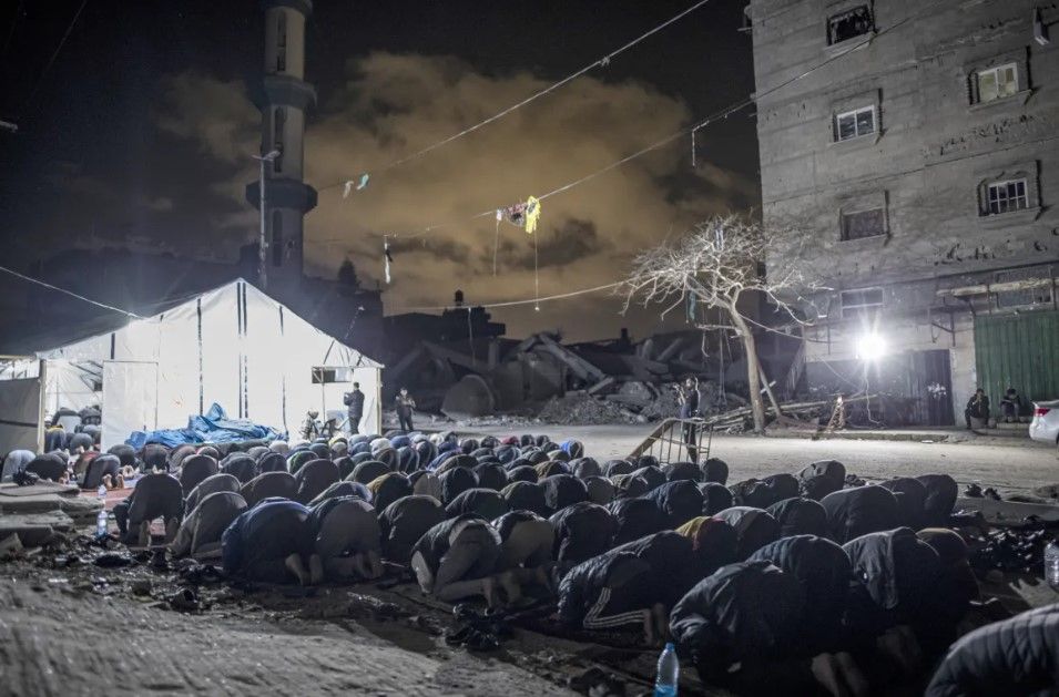 Palestinians gather to pray on the night of Laylat al-Qadr near the debris of al-Faruq Mosque in Rafah, southern Gaza.