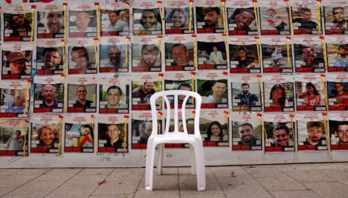 A Chair Is Left In Front Of Posters With Pictures Of Hostages, Who Were Kidnapped During  October 7 Attack On Israel by Palestinian Islamist Group Hamas. Photo: Reuters