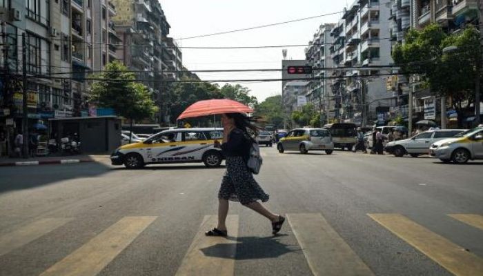 A Woman Walks Under An Umbrella To Shelter From The Sun During A Heatwave, In Yangon On April 2, 2024. Photo: Collected 