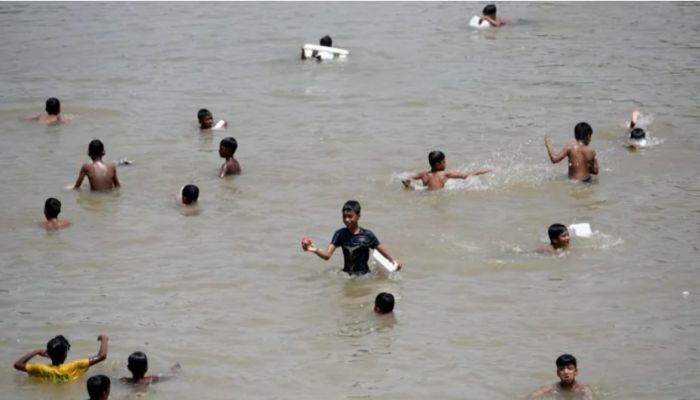 Children Cool Off In A Take On A Hot Day In Dhaka. Photo: Collected 