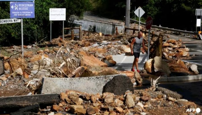 A Resident Walks Past Fallen Rocks And Debris From A Landslide In Wollongong Caused By Heavy Rain In Eastern Australia on Apr 6, 2024. Photo: AFP